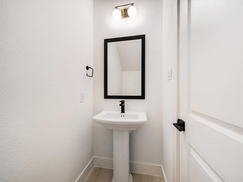 Bathroom featuring light wood-type flooring and baseboards