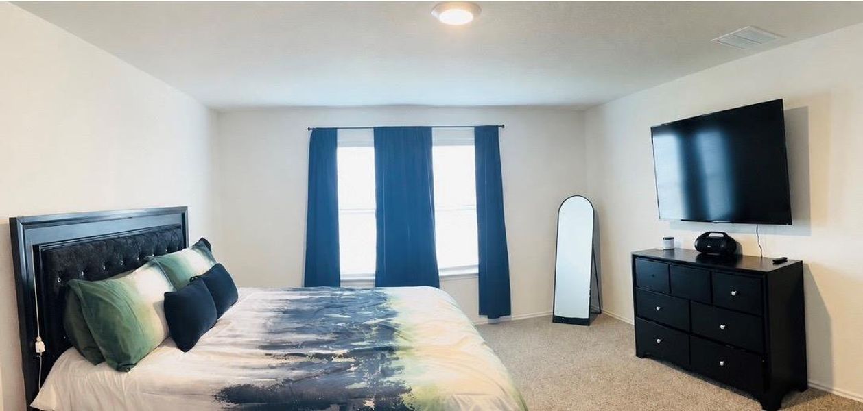 Spacious room featuring neutral carpeting and light-toned walls Spacious room featuring neutral carpeting and light-toned walls