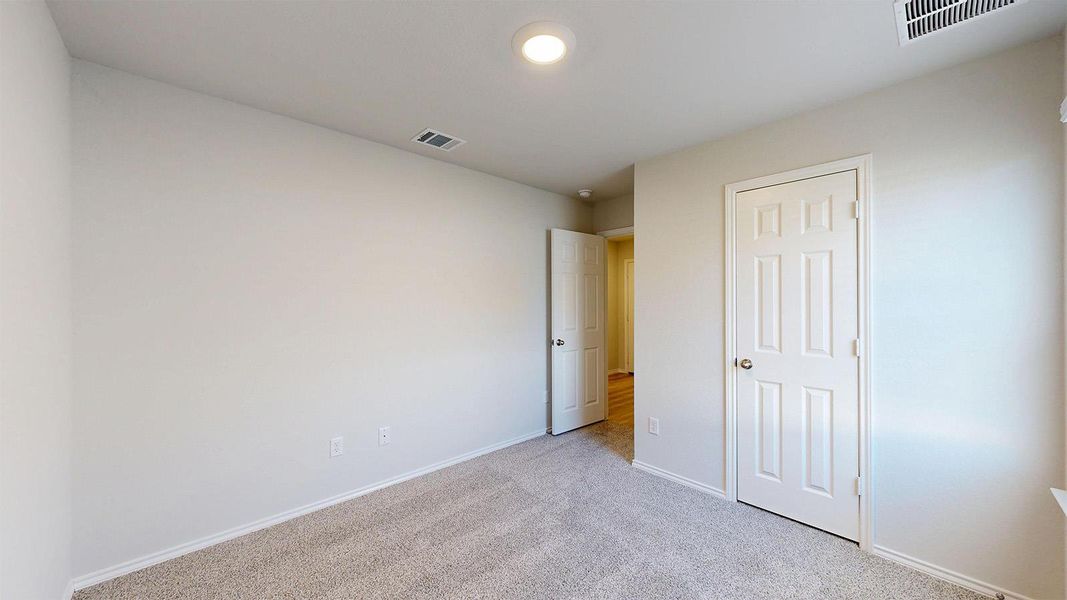 Carpeted room with neutral wall finishes and white trim