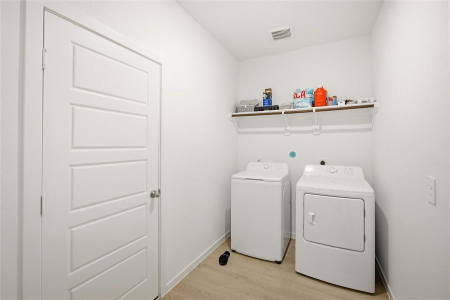 Laundry room — Dedicated laundry room with washer, dryer, and overhead storage shelf. Laundry room — Dedicated laundry room with washer, dryer, and overhead storage shelf.