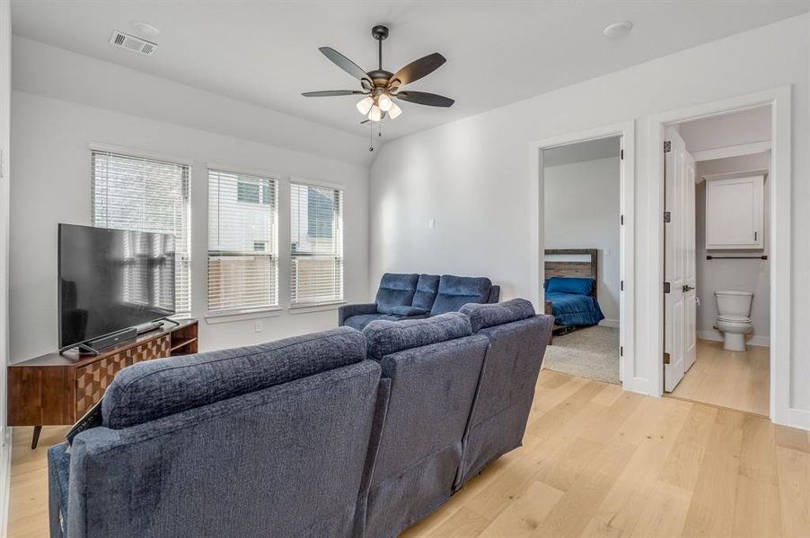 Living room featuring light hardwood / wood-style floors and ceiling fan