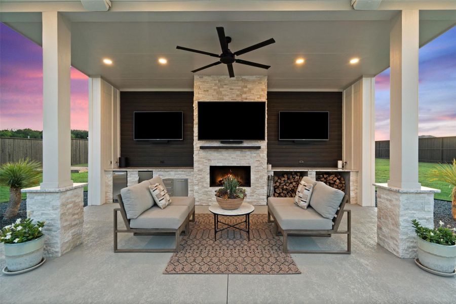 An inviting covered patio offers a fireplace and built-in entertainment for evening relaxation. An inviting covered patio offers a fireplace and built-in entertainment for evening relaxation.