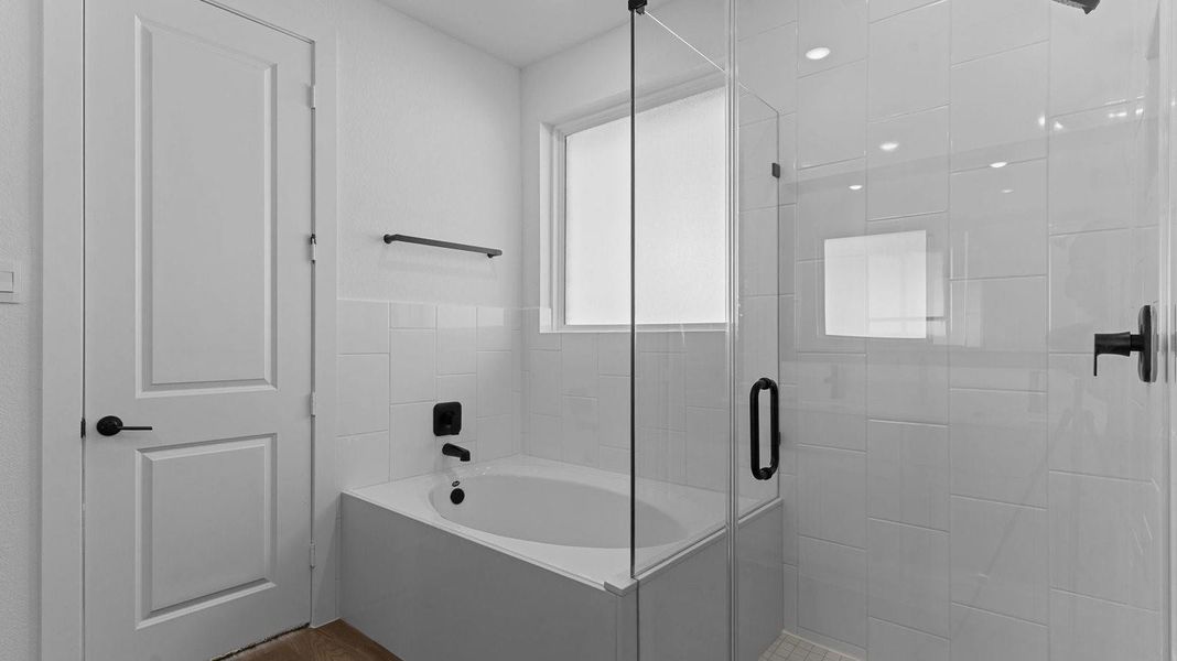 Primary bathroom with a soaking tub and standing shower