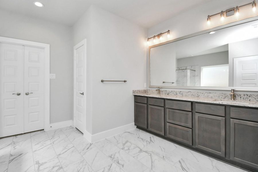 Another view of the primary bath. Sample photo of completed home with similar floor plan. Actual colors and selections may vary.