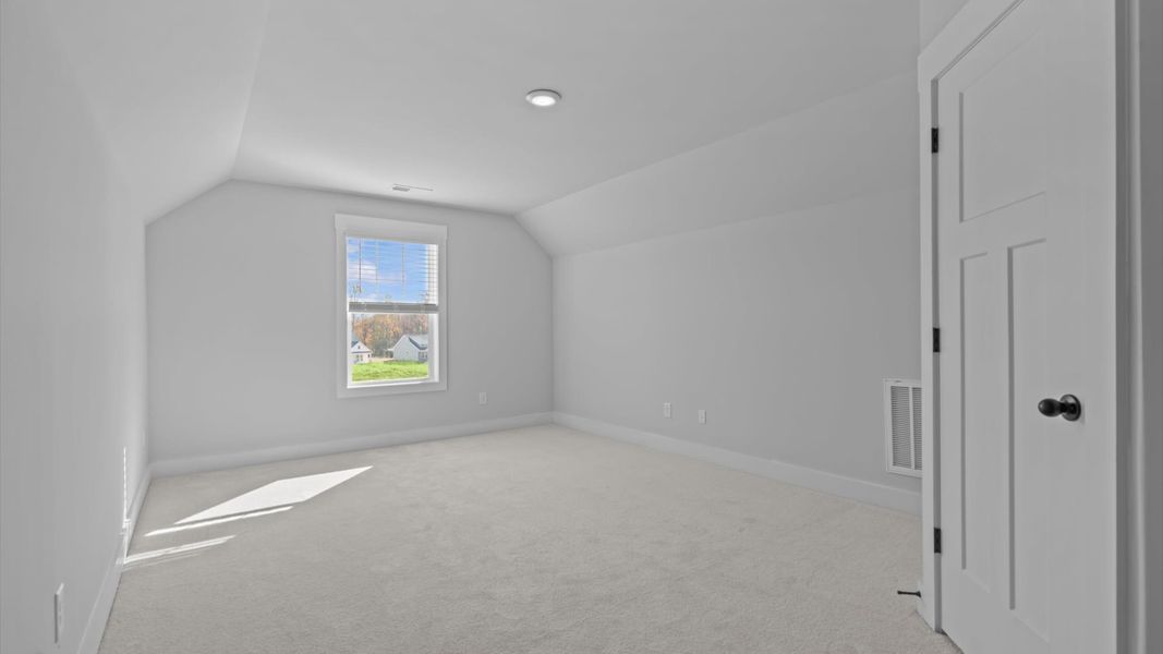 Accomplished design in this restful bedroom featuring plush carpet and oversized window views