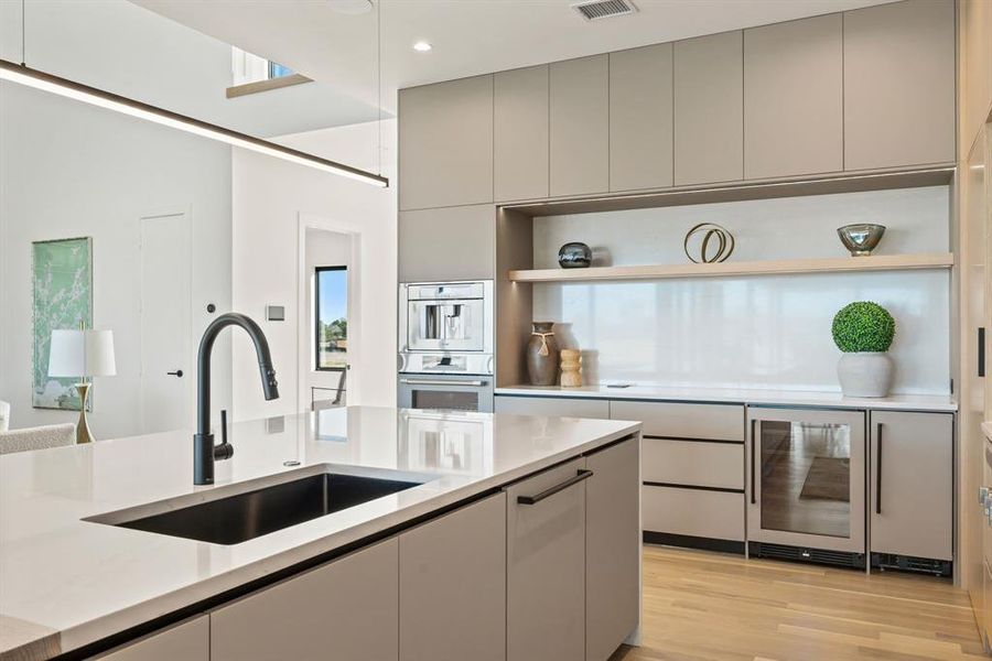 Luxury kitchen with professional-grade appliances and waterfall island. Luxury kitchen with professional-grade appliances and waterfall island.