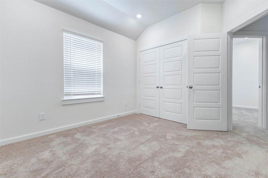 This bedroom features a bright window with blinds, soft carpet, high ceilings, and a double-door closet for added storage. The neutral color palette and clean finishes create a fresh, welcoming space that can easily fit a variety of furniture layouts and personal styles. This bedroom features a bright window with blinds, soft carpet, high ceilings, and a double-door closet for added storage. The neutral color palette and clean finishes create a fresh, welcoming space that can easily fit a variety of furniture layouts and personal styles.