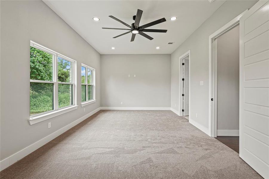 Bedroom with carpet flooring, ceiling fan, and recessed lighting