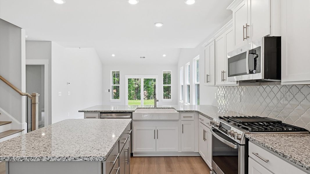 Beautifully appointed kitchen with spacious counters and sophisticated detailing at Creeks at Midway
