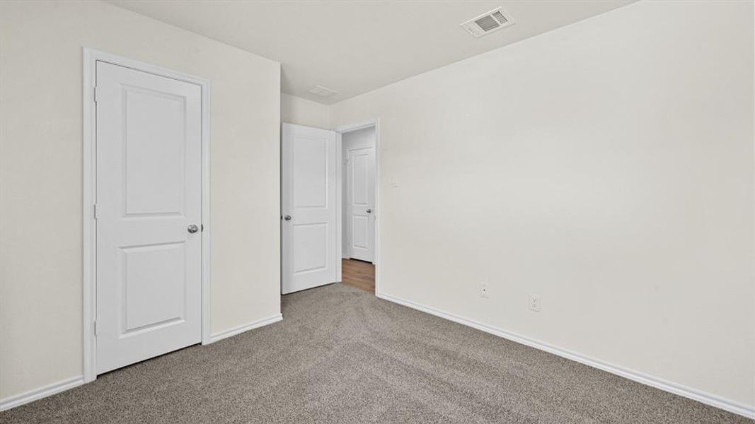 Unfurnished bedroom featuring baseboards and carpet flooring