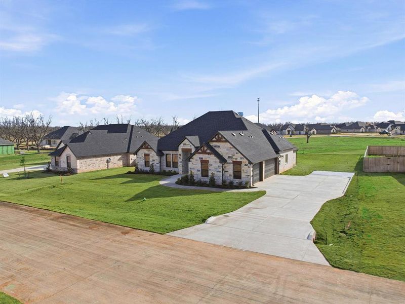 Front exterior of a new home in , Granbury, TX, highlighting curb appeal (Image 22).