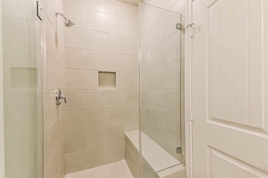 Take a look at this stunning walk-in shower with a stylish bench. Take a look at this stunning walk-in shower with a stylish bench.