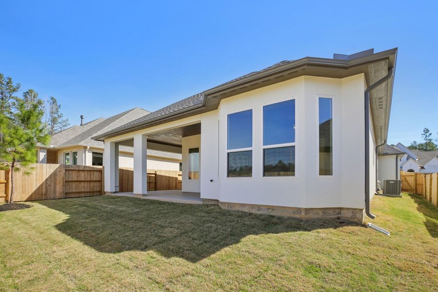 Exterior details and patio area of a home in Woodhavyn 50', Magnolia (Image 4).