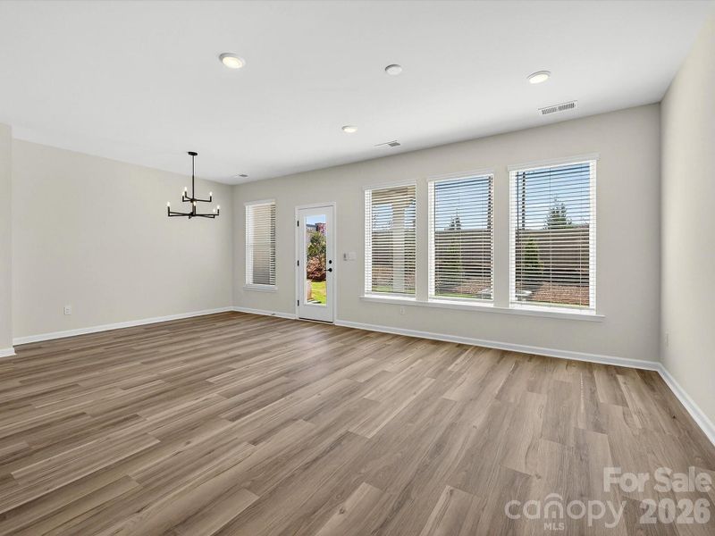 open, bright living room with 3 large picture windows bathes the area with natural light