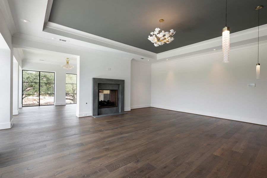 Primary suite with fireplace and room for large furniture.