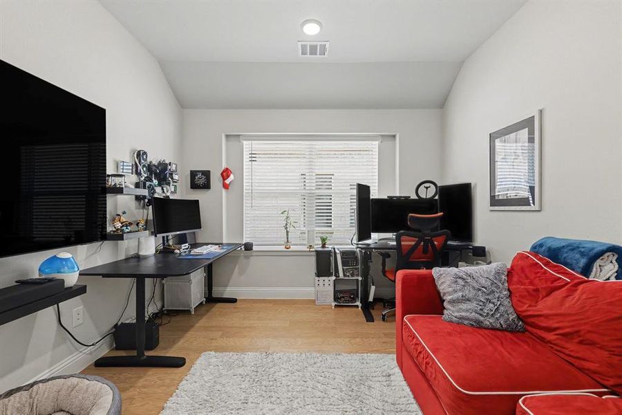 Room with wood-finish flooring and light-toned walls