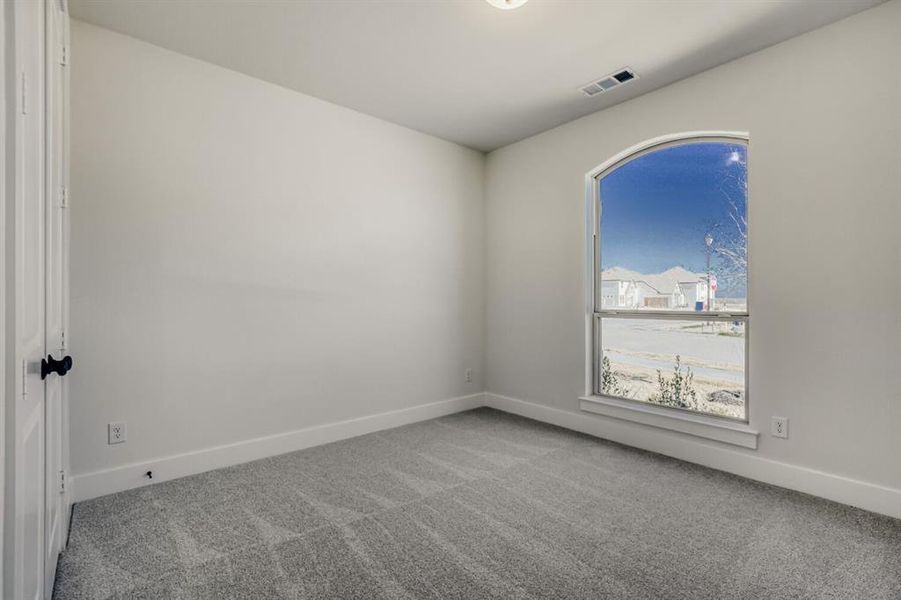 Unfurnished room with light carpet and baseboards