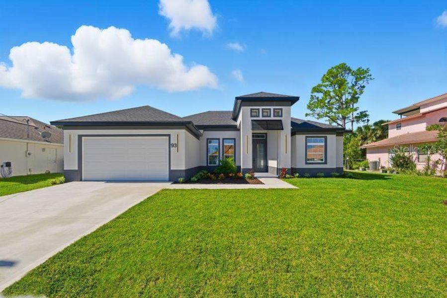 Front exterior of a new home in , Palm Coast, FL, highlighting curb appeal (Image 24).