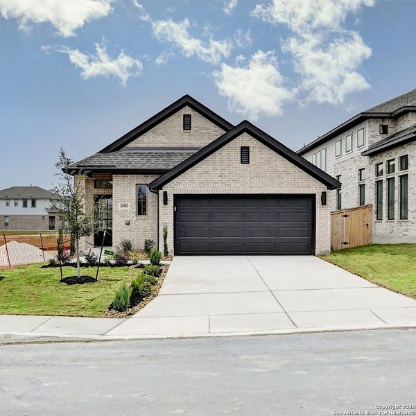 Front exterior of a new home in Ladera 40', San Antonio, TX, highlighting curb appeal (Image 2).