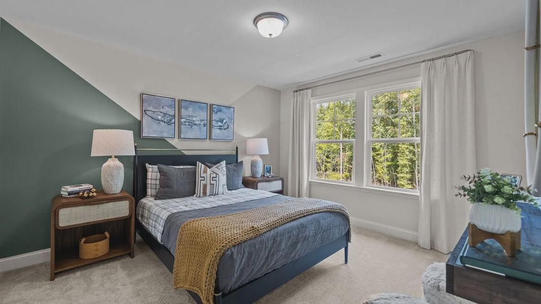Ample secondary bedroom with elevated ceiling and large windows, in the Townsend Design by DRB Homes in York, SC
