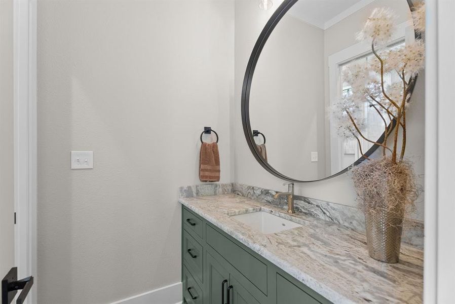 Bathroom featuring vanity and ornamental molding