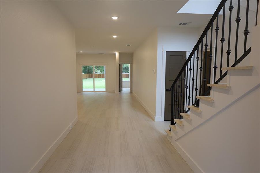 Corridor featuring recessed lighting and stairway