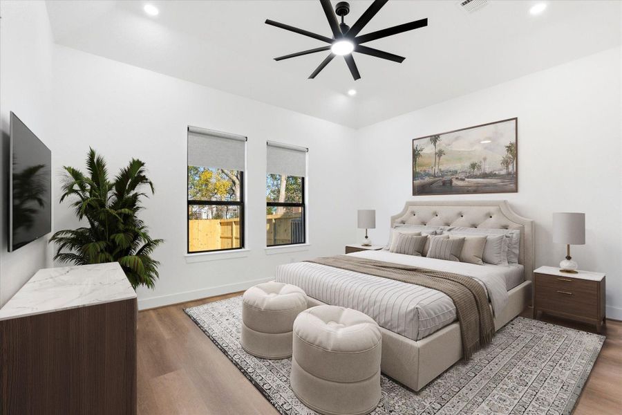 The primary suite, conveniently located on the first floor, showcases 11-foot ceilings, recessed lighting, and an exceptional en-suite retreat. (Virtually Staged)