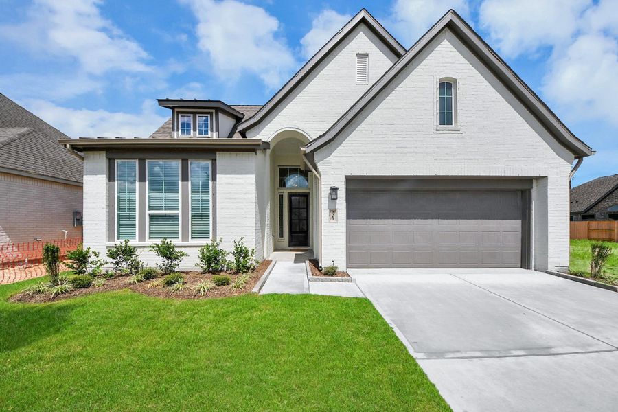 Front exterior of a new home in Meridiana Courtyard Collection, Manvel, TX, highlighting curb appeal (Image 2).