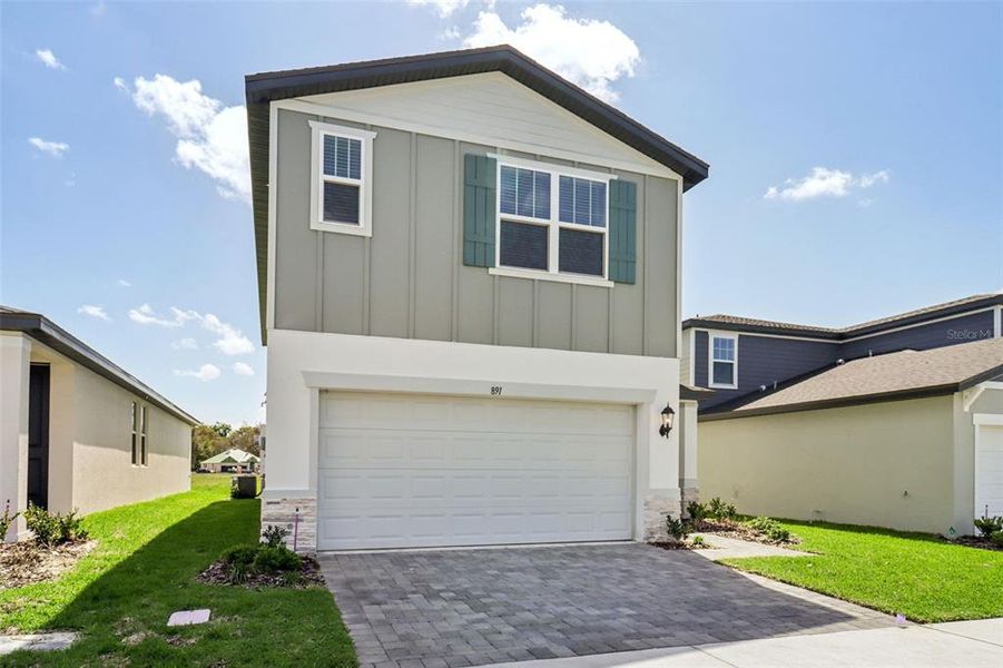 Front exterior of a new home in The Reserve at Hammock Oaks - Classic Series, Lady Lake, FL, highlighting curb appeal (Image 20).