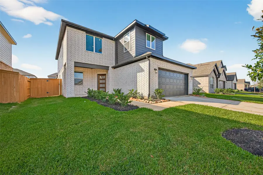 Front exterior of a new home in Sunterra, Katy, TX, highlighting curb appeal (Image 1). Front exterior of a new home in Sunterra, Katy, TX, highlighting curb appeal (Image 1).