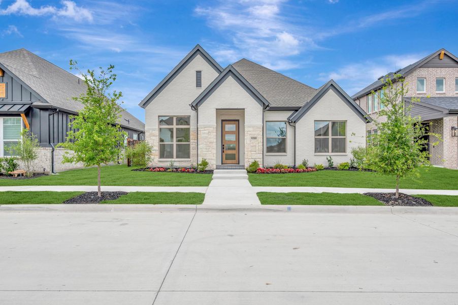Front exterior of a new home in Talia – Garden Series, Mesquite, TX, highlighting curb appeal (Image 1). Front exterior of a new home in Talia – Garden Series, Mesquite, TX, highlighting curb appeal (Image 1).