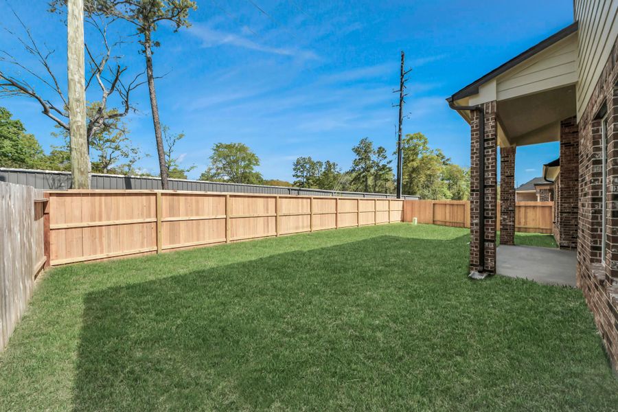 Experience outdoor living at its finest on this expansive covered patio, thoughtfully designed for BBQs and delightful outdoor dining.