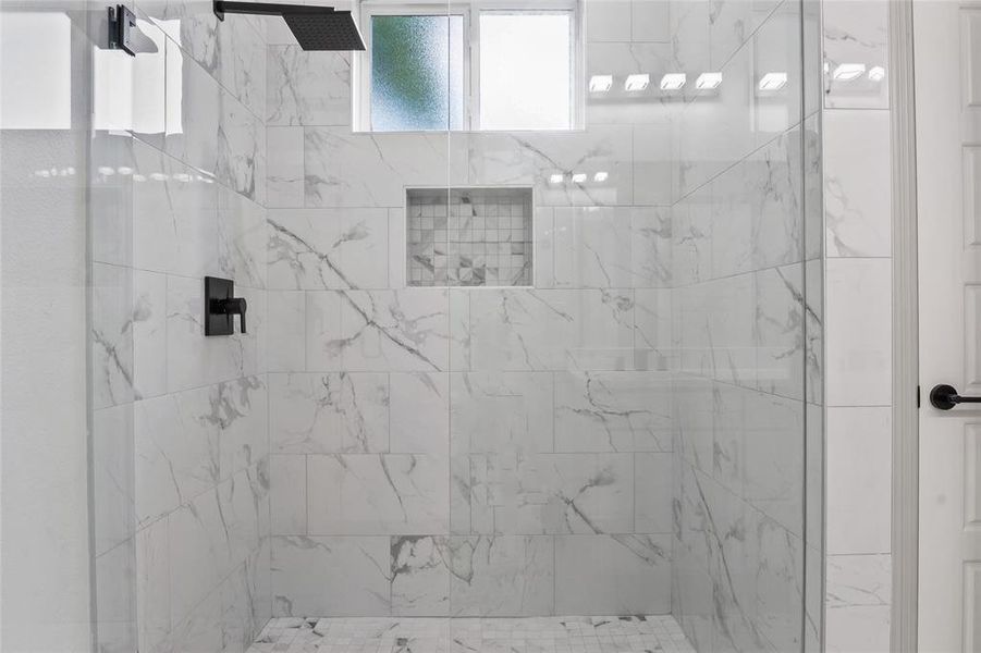 Full bath featuring a tile shower Full bath featuring a tile shower
