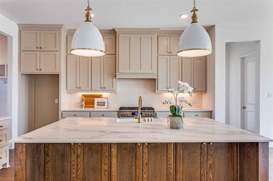 Kitchen featuring backsplash, cream cabinets, light stone counters, dark wood-type flooring, and recessed lighting Kitchen featuring backsplash, cream cabinets, light stone counters, dark wood-type flooring, and recessed lighting