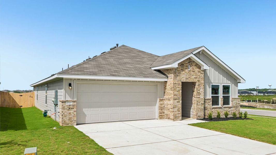 Front exterior of a new home in Carillon, Manor, TX, highlighting curb appeal (Image 17).