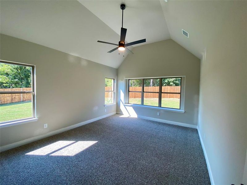 Master bedroom offers vaulted ceilings, ample windows, and ceiling fan Master bedroom offers vaulted ceilings, ample windows, and ceiling fan