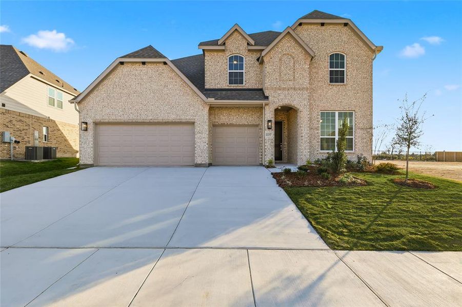 View of front facade with a front lawn, concrete driveway, brick siding, and a garage View of front facade with a front lawn, concrete driveway, brick siding, and a garage