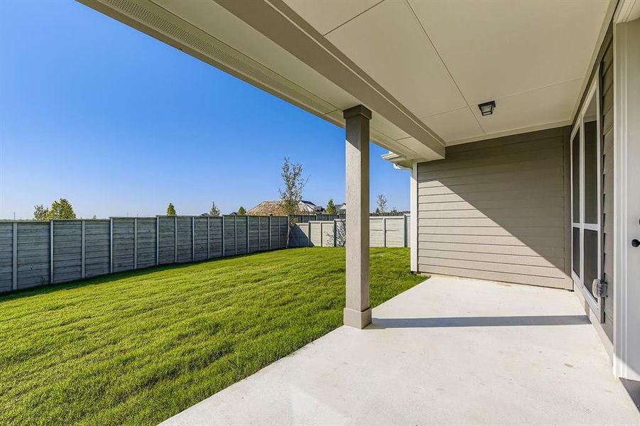Fenced backyard with a patio area