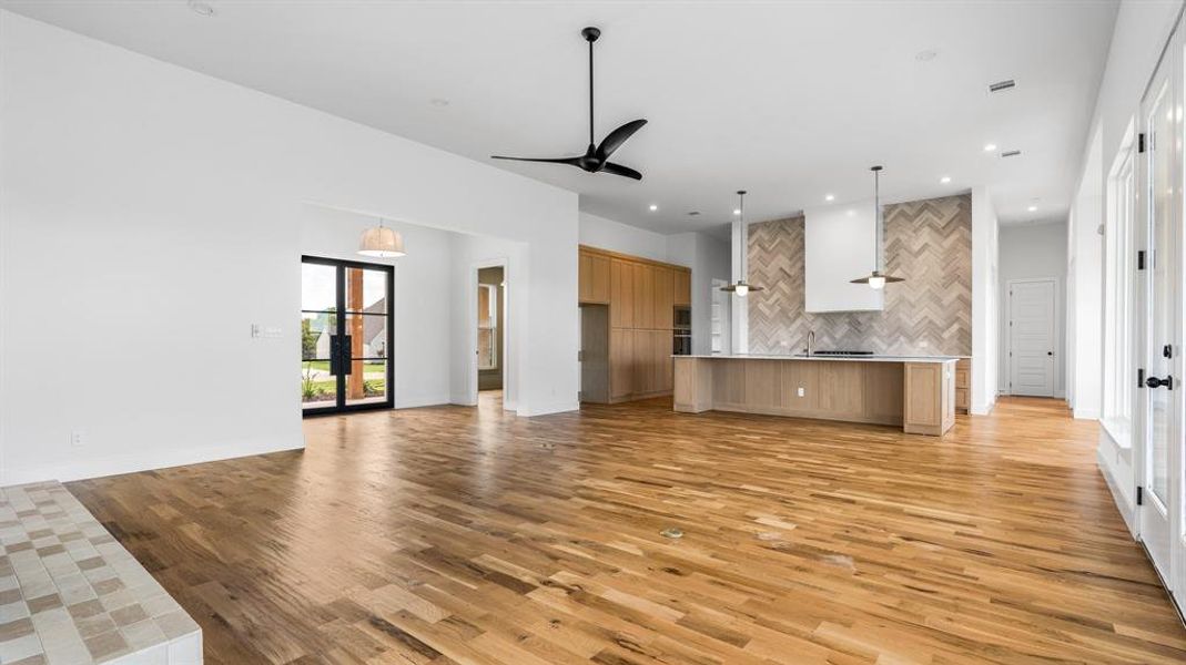 Unfurnished living room featuring light hardwood / wood-style flooring and ceiling fan