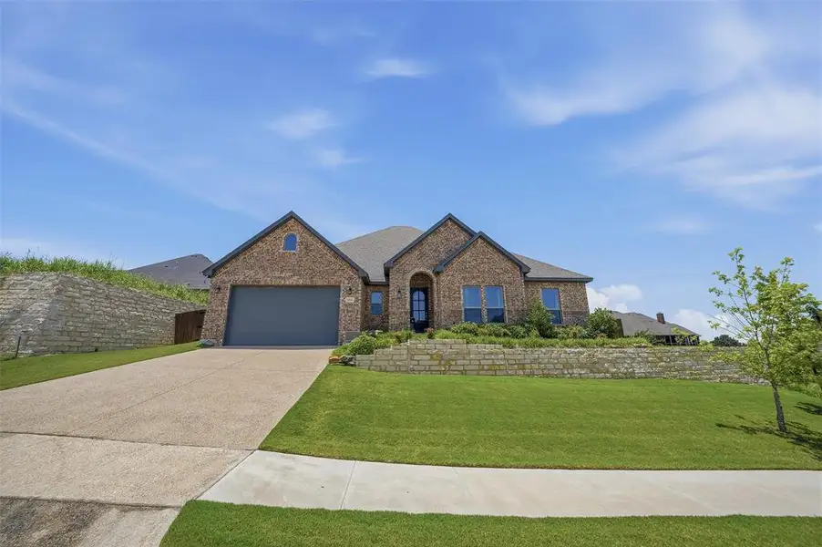 Front exterior of a new home in , Benbrook, TX, highlighting curb appeal (Image 2). Front exterior of a new home in , Benbrook, TX, highlighting curb appeal (Image 2).
