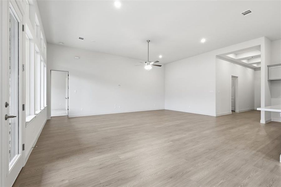 Unfurnished room with ceiling fan, light wood-style floors, and recessed lighting