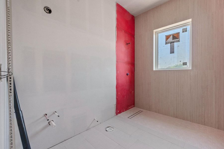 Gameroom bathroom will feature white oak cabinetry and champagne gold fixtures for a cohesive, elevated design. Conveniently shared between the gameroom and fourth bedroom.