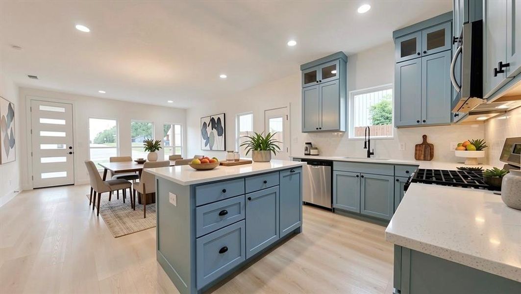 Kitchen featuring a central island with quartz countertops and blue cabinetry