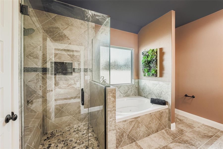 Full bathroom featuring a shower stall and a whirlpool tub