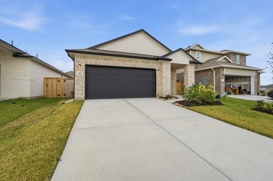 Front exterior of a new home in Windrose Green, Angleton, TX, highlighting curb appeal (Image 19).