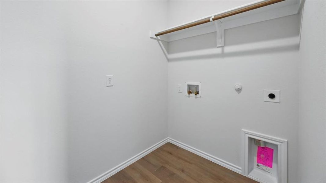 Laundry room with gas dryer hookup, dark wood finished floors, hookup for a washing machine, and electric dryer hookup