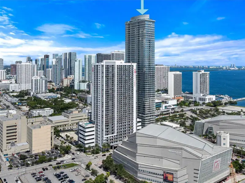 High-rise architectural structure featuring a glass facade, multiple balconies, and a prominent cylindrical crown High-rise architectural structure featuring a glass facade, multiple balconies, and a prominent cylindrical crown