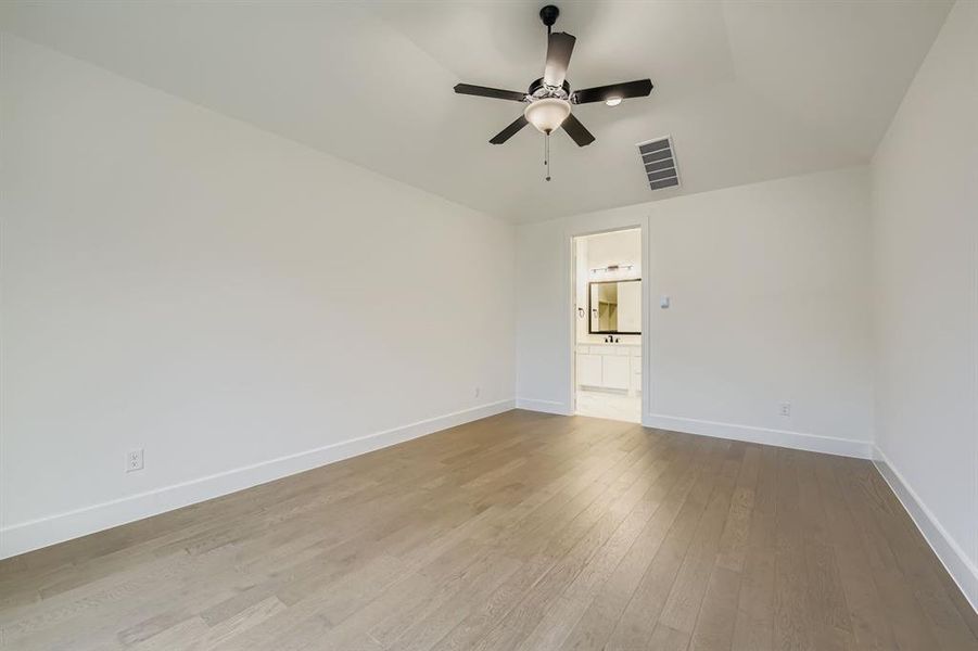 Spare room featuring light wood finished floors and a ceiling fan