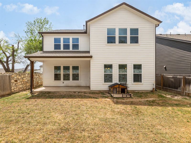Back of house with a patio area, a fenced backyard, and roof with shingles
