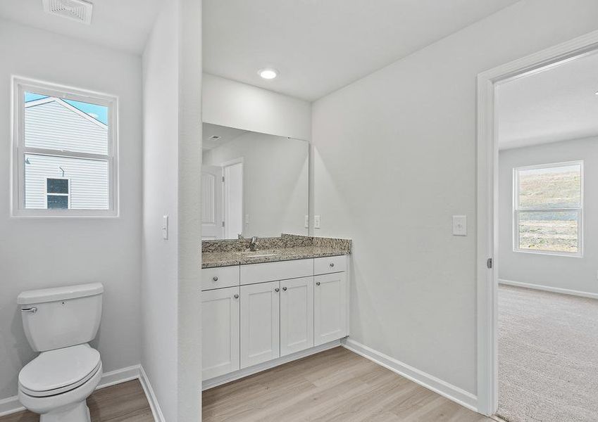 Master bath with a window and a vanity.